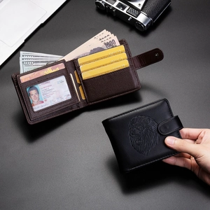 Macro detail of men's leather wallet interior showing multiple card slots and lion head embossing