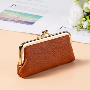 Detailed view of brown litchi pattern leather coin purse with vintage gold metal clasp