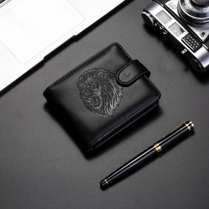 Close-up of embossed lion head pattern on premium black leather men's wallet with neat stitching