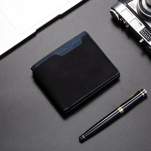 Detail of short bifold wallet for men featuring matte leather texture and eagle logo engraving