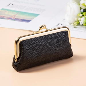Close-up of black litchi texture PU leather coin purse with vintage gold metal frame