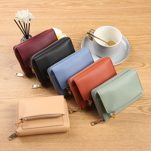 Women's minimalist litchi texture small wallets in six colors with gold zipper on wood desk