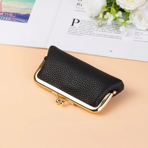 Close-up of black litchi pattern PU leather mini pouch with gold metal clasp closure