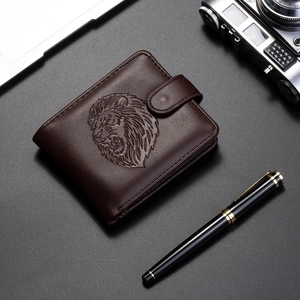 Detail of dark brown leather wallet with embossed lion head and snap closure design