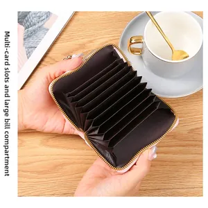 Internal accordion view of pink mini wallet showing multi-card slots and bill pocket