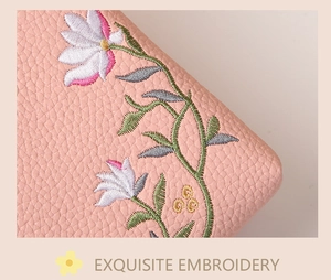 Close-up of litchi pattern leather phone bag with delicate floral embroidery details