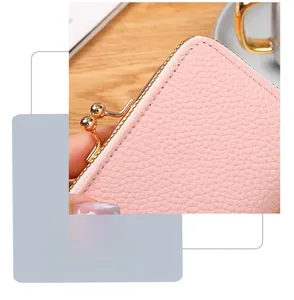 Close-up of pink pebbled leather wallet featuring gold kiss-lock and fine stitching