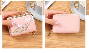 Close-up of pink faux leather coin purse with floral embroidery and metal clasp
