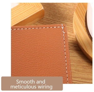 Macro detail of brown lychee grain leather wallet with white contrast stitching