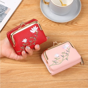 Close-up of red and pink litchi grain coin purses with elegant floral embroidery detail