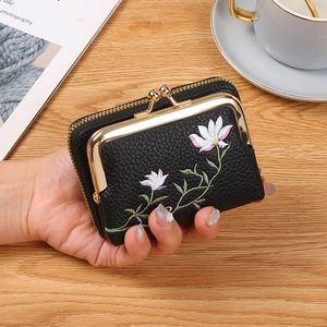 Mini black leather coin purse with floral embroidery and gold kiss-lock closure