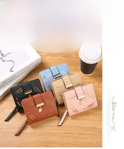 Detailed view of hollow leaf pattern and metal pendants on stylish short wallets