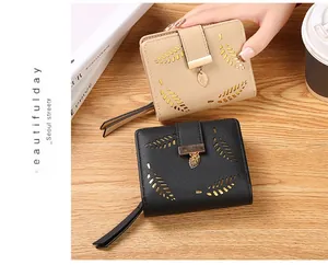 Detail of leaf hollow pattern on short wallet with golden leaf pendant and zipper