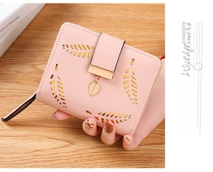 Pink short bifold wallet for women featuring laser-cut leaf pattern and metal pendant