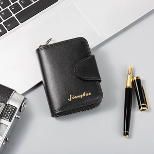 Close-up of black leather business card holder with zipper and buckle on office desk