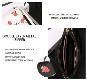 Close-up of double metal zippers and fruit pattern texture on compact wallet
