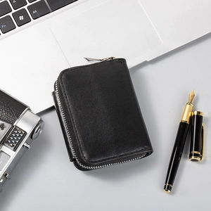 Close-up of black leather card holder with premium grain texture and silver zipper