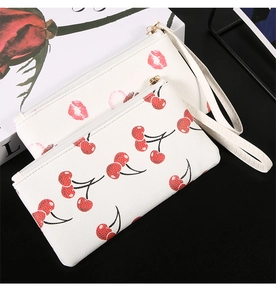 Set of two printed PU leather pouches with red cherry and lip patterns and wrist straps
