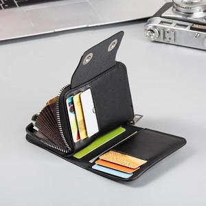 Detail view of the black leather accordion card holder with multiple slots and zip pocket