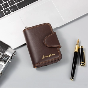 Detail of deep brown leather wallet with vintage zipper, buckle, and contrast stitching