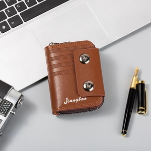 Brown multi-slot leather wallet shown with a laptop and pen in a business setting