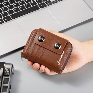 Brown leather accordion wallet with dual silver snap buttons and zipper pocket details