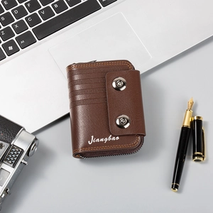 Close-up of men's brown leather card wallet styled with a laptop and camera