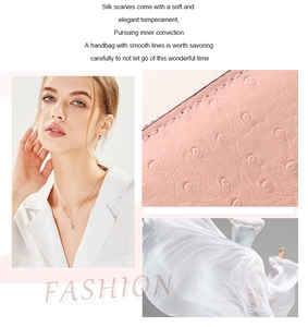 Detailed view of pink ostrich texture faux leather clutch and silver diamond pendant necklace