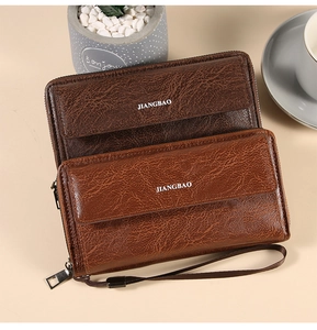 Close-up of retro oil wax leather texture and zipper detail on large men's wallets