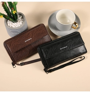 Detail of vintage textured leather wallets in black and brown with secure wrist straps