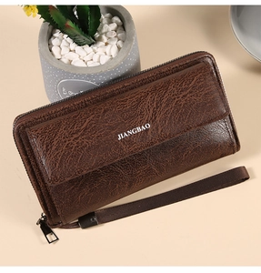 Detailed macro view of dark brown leather texture and zipper on men's business clutch bag