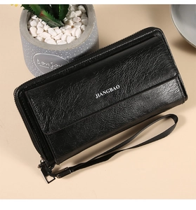 Detailed view of large capacity black zippered wallet clutch with a wrist strap and texture
