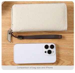 Ostrich embossed PU leather long wallet size compared to an iPhone with wrist strap