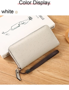 Detailed macro view of white ostrich pattern leather texture and metal zipper on wallet