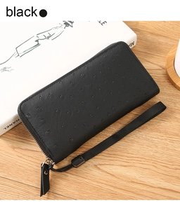 Detail of black ostrich embossed PU leather long wallet with wrist strap and zipper