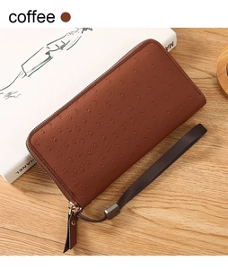 Detail of coffee brown ostrich pattern leather wallet with zip and braided strap