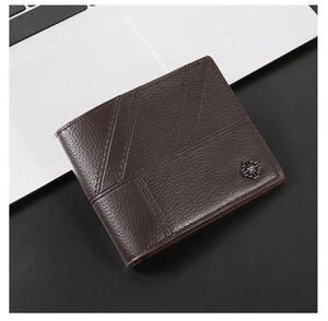 Detail of dark brown litchi grain leather wallet with diagonal stitching and metal logo