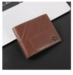Detailed macro view of brown leather wallet featuring pebbled texture and metal logo