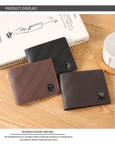 Business men's wallets in black and brown leather with textured finish on wooden desk