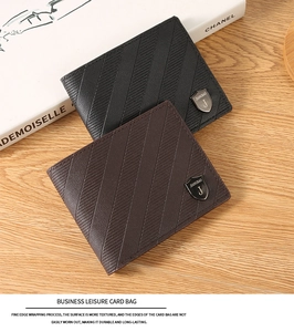 Close-up of leather men's wallet with textured surface and metallic shield logo