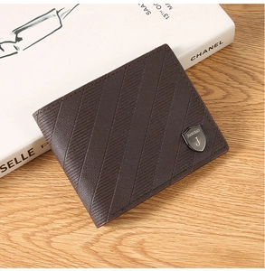 Macro detail of men's dark brown leather bifold wallet with textured grain and logo
