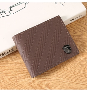 Detailed close-up of brown men's wallet with twill texture and shield metal logo