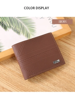 Detail view of a brown bifold wallet with horizontal stitching and metal logo on wood
