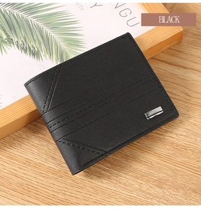 Macro shot of men's black lychee leather wallet with silver metal buckle detail