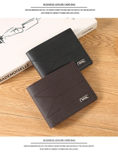 Close-up of black and brown men's wallets with embossed texture on wooden surface