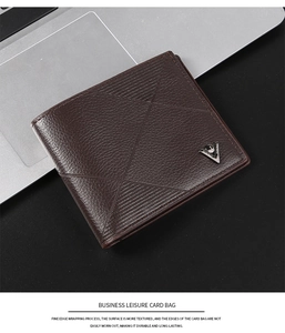 Detail of dark brown litchi grain leather wallet with geometric embossing and metal logo