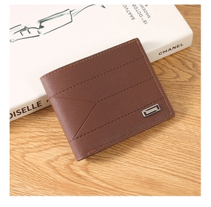 Macro detail of brown leather wallet featuring triple stitching and silver metal logo brand