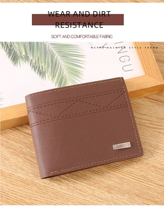 Detailed view of brown men's wallet with triangle embossing and orange stitching