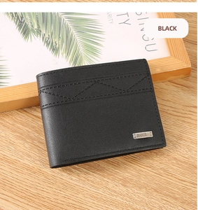 Close-up of black bifold wallet with grain texture, metal logo and triangle stitching