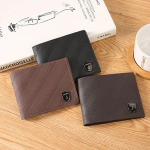 Three-color minimalist men's leather wallets in black and brown on a wooden desk